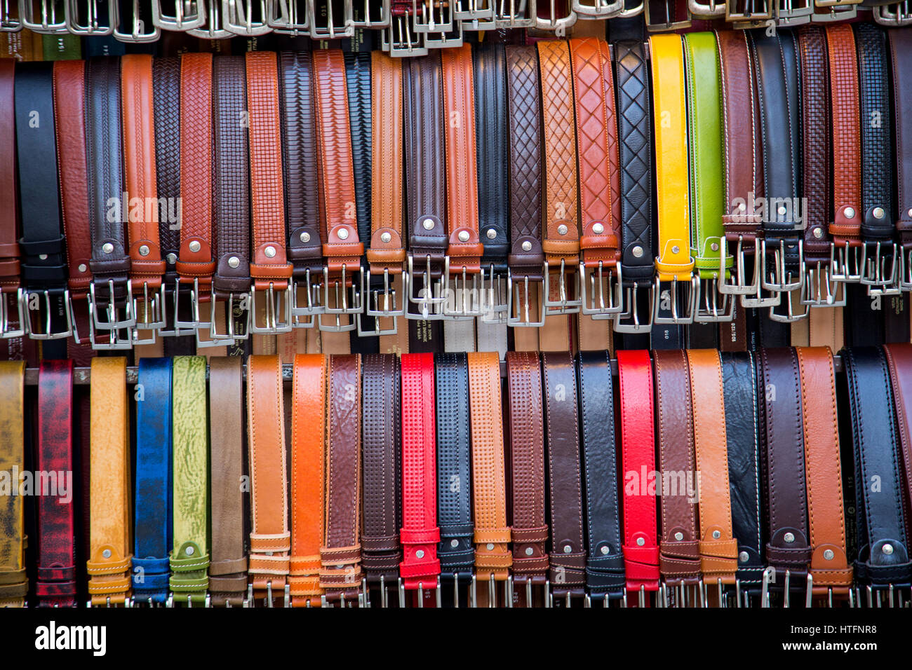 Leather belts displayed for sale at the San Lorenzo leather market in Florence Italy Stock Photo