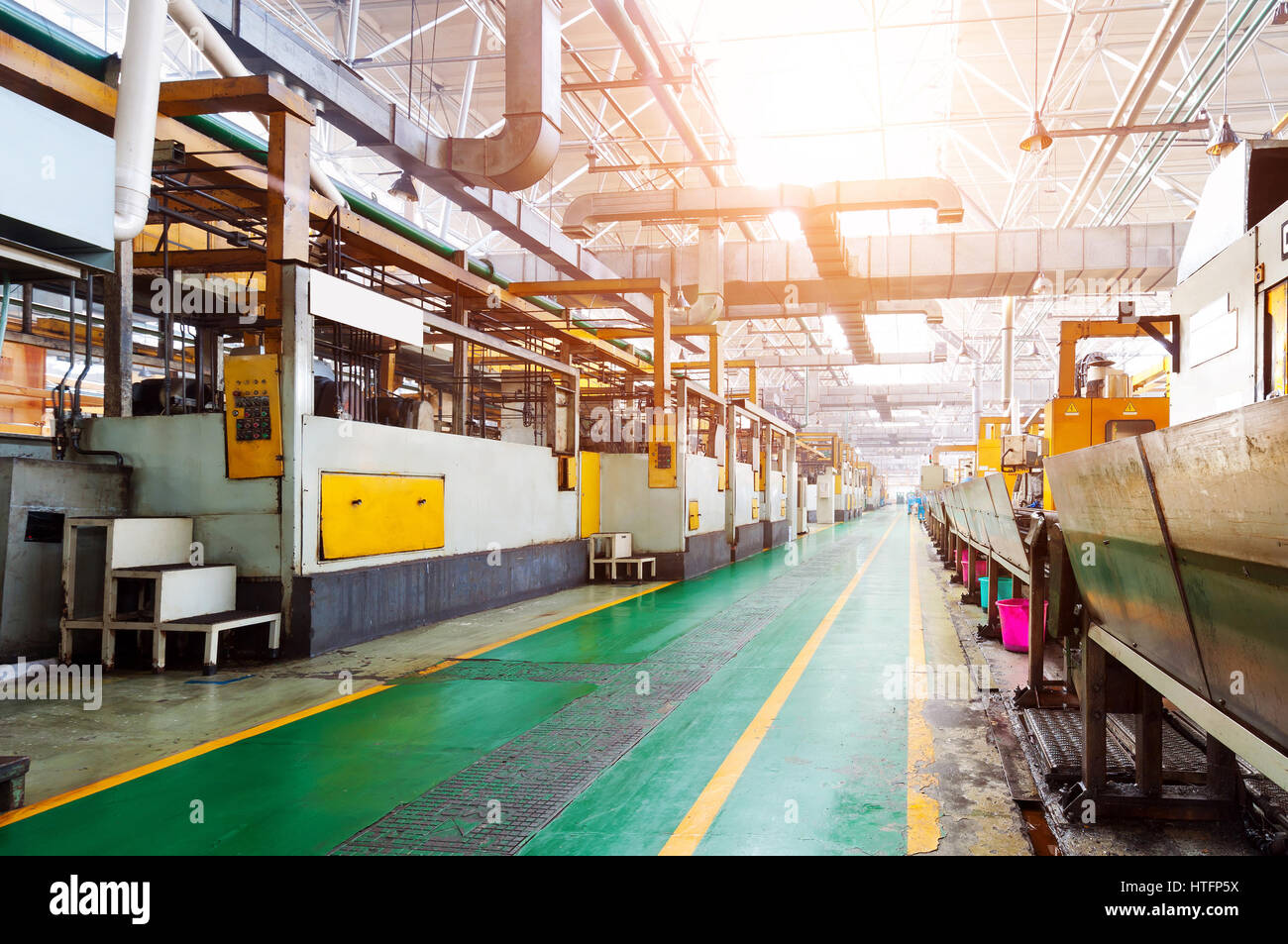 Shop inside the old factory, criss-crossing pipes and ventilation ducts Stock Photo