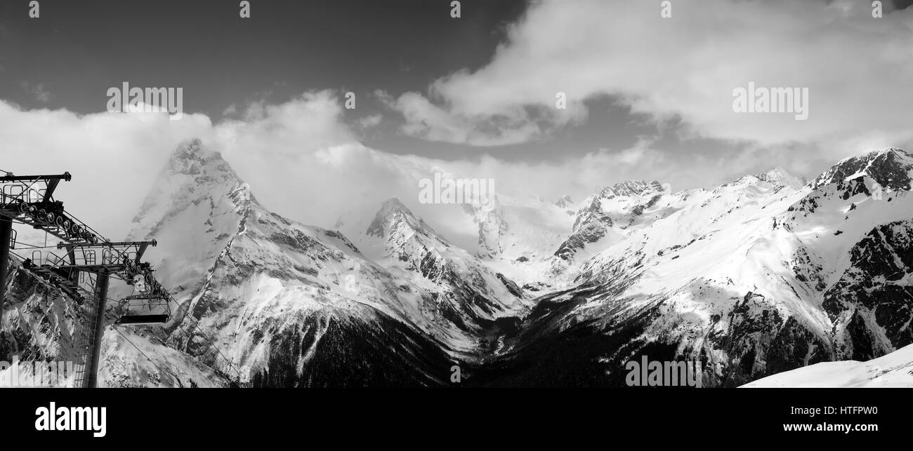 Black and white panoramic view on snow mountains in clouds. Caucasus ...
