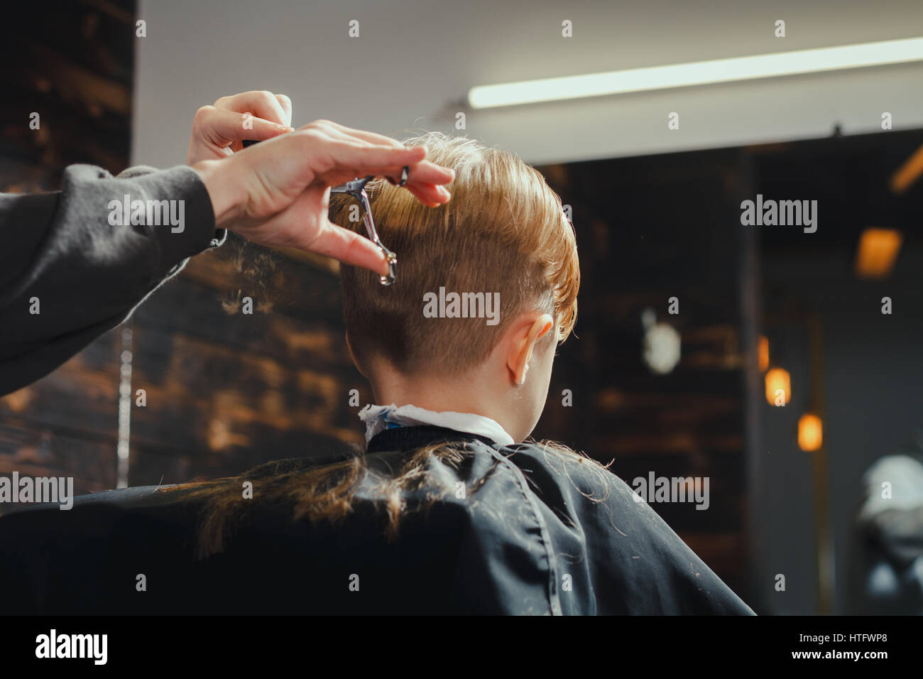 Little Boy Getting Haircut By Barber. Barbershop Theme Stock Photo