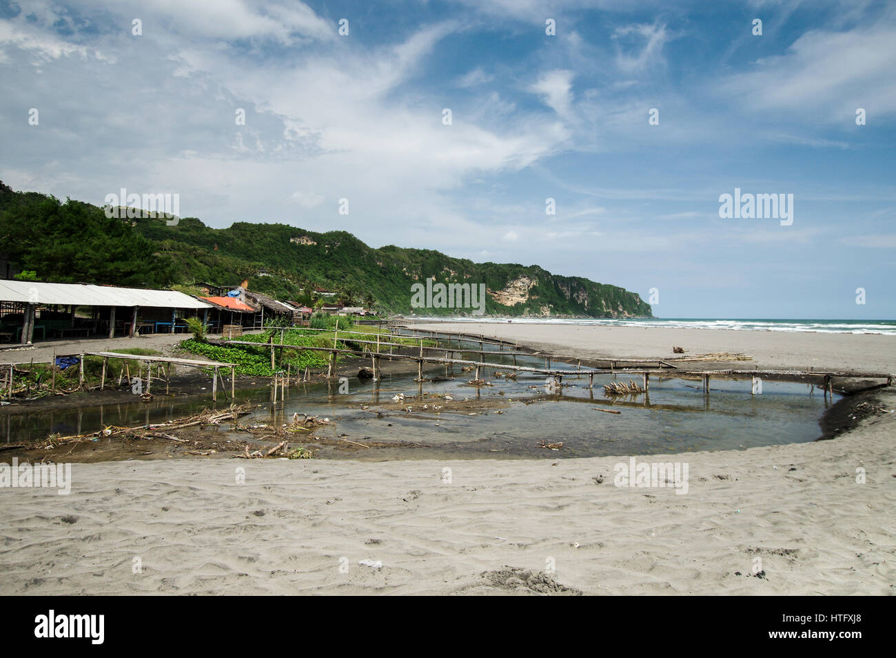Dilapidated shacks on the beautiful Parangtritis Beach in Central Java, Indonesia Stock Photo