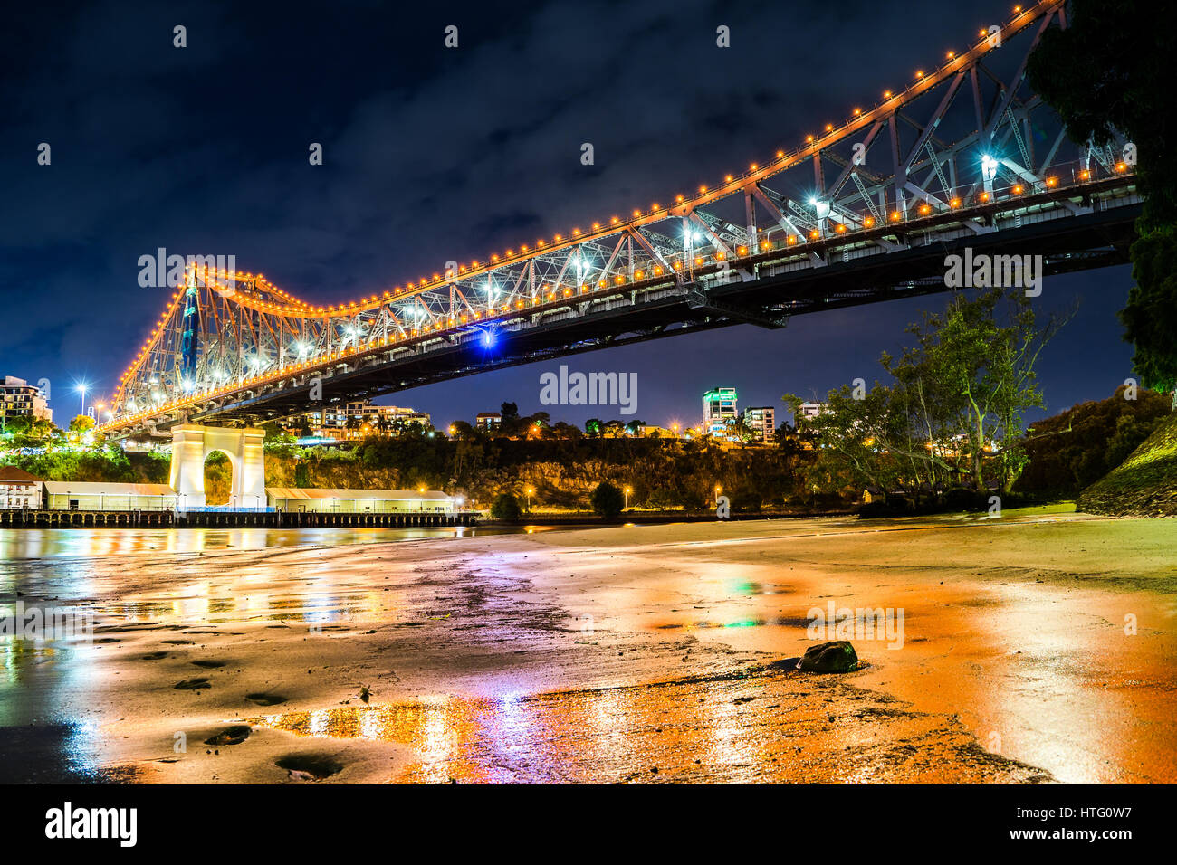Closeup of the Brisbane Story Bridge. One of the main icons in Brisbane city. Orange lighting over the bridge Stock Photo