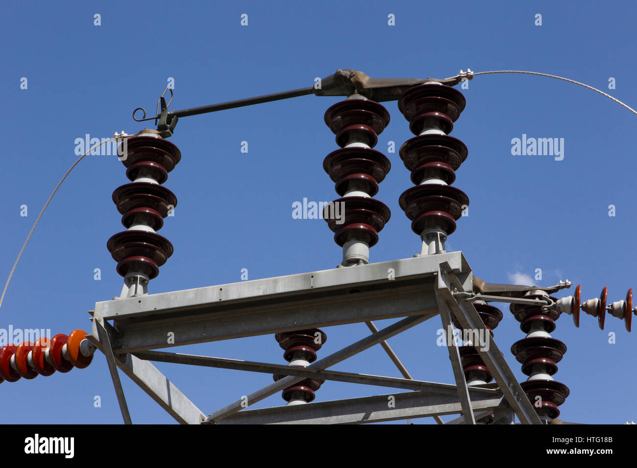High-voltage insulators on an electrical transmission tower, Cabinet Gorge Dam, Clark Fork River, ID. Stock Photo