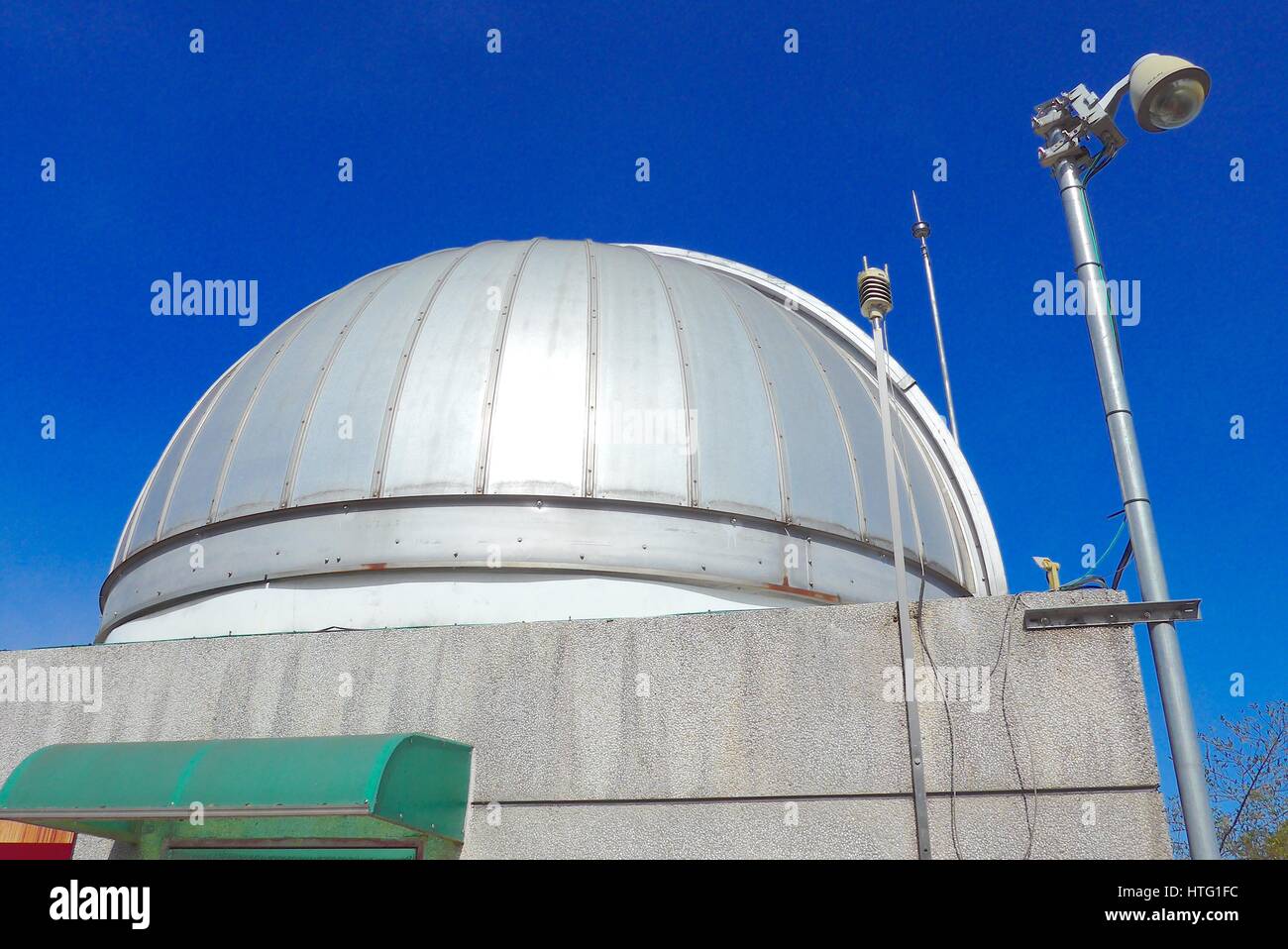 Astronomical observatory dome closeup in blue sky Stock Photo