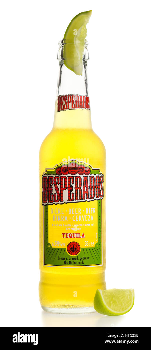Bottle of Mexican Desperados Tequila beer with lime wedge isolated