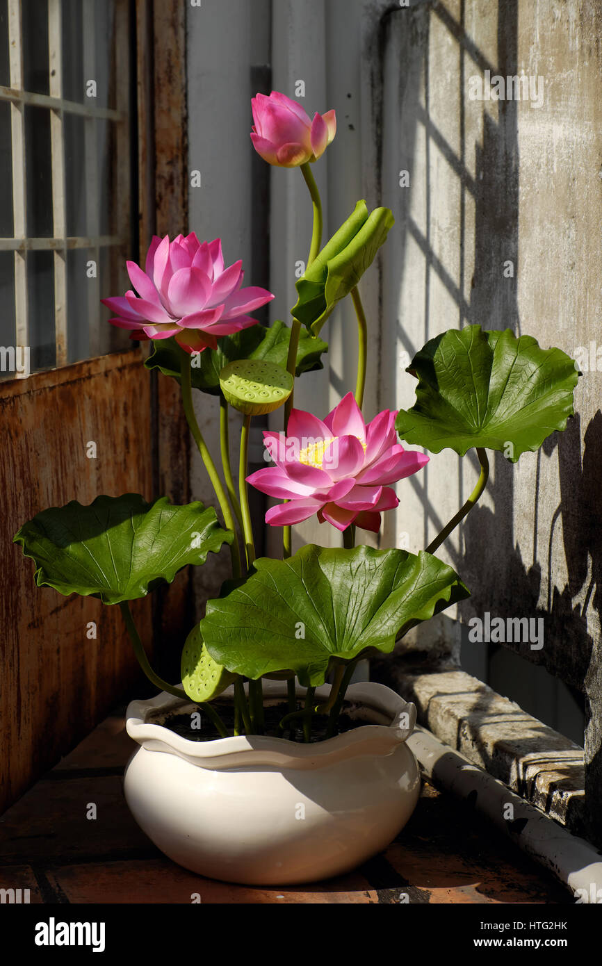 Artificial flower, handmade lotus flower with green leaf and pink petal make from clay, diy art product for home decoration Stock Photo