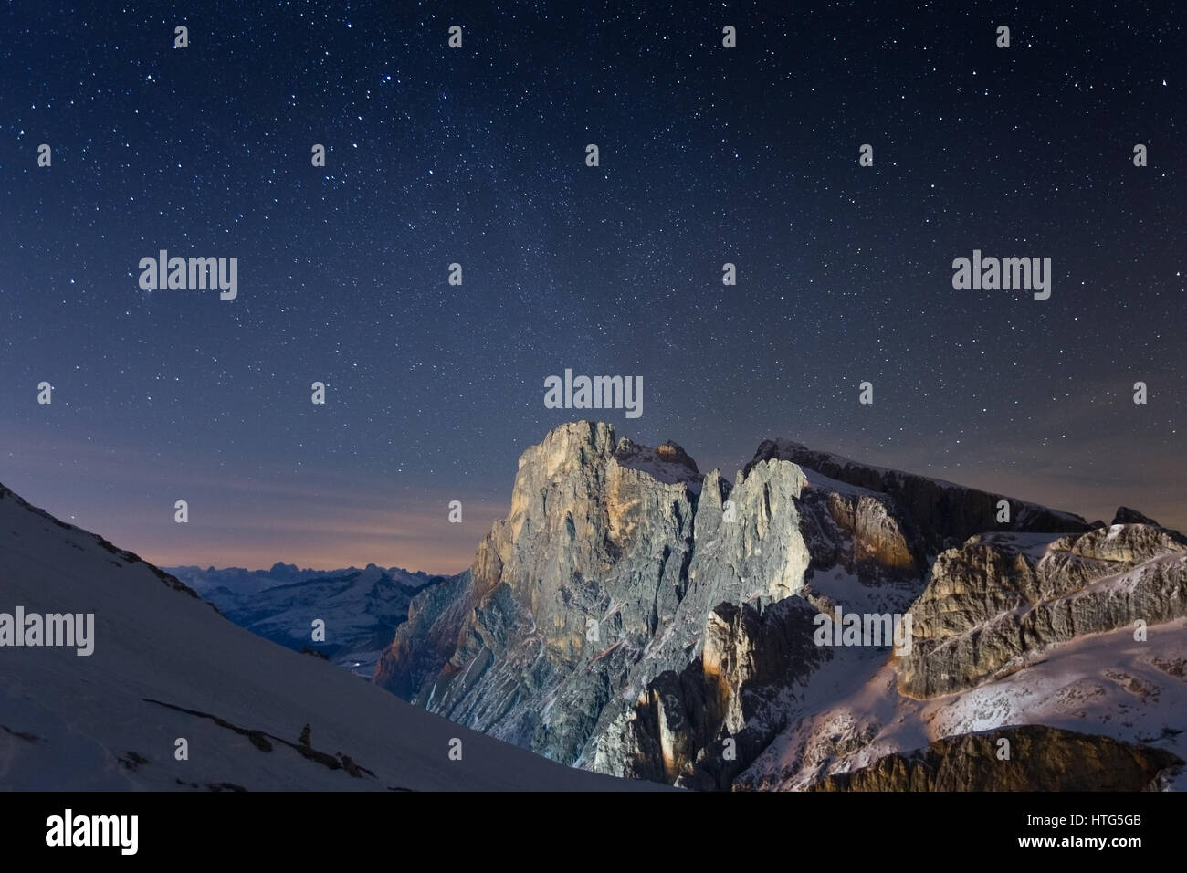 Cimon della Pala peak. The Pale di San Martino mountain group at night. Starry sky. The Dolomites of Trentino. Italian Alps. Europe. Stock Photo