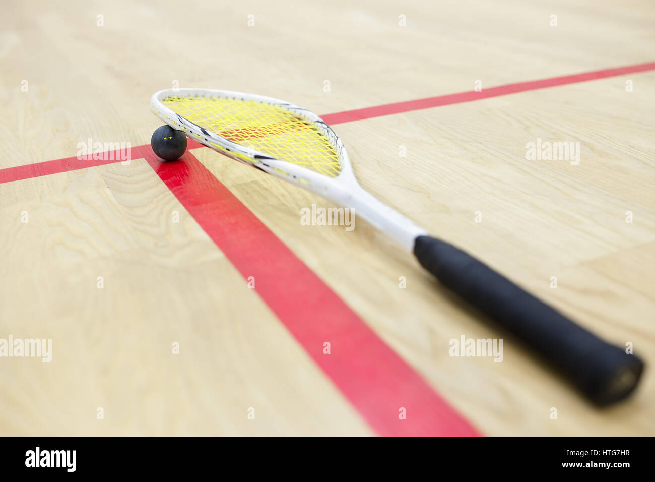 squash racket and ball on the wooden background. Racquetball equipment ...