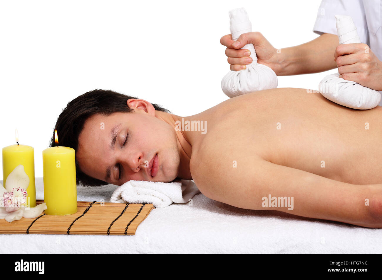 Thai Ball Massage. Man getting SPA thai herbal compress massage. Isolated  on white background Stock Photo - Alamy