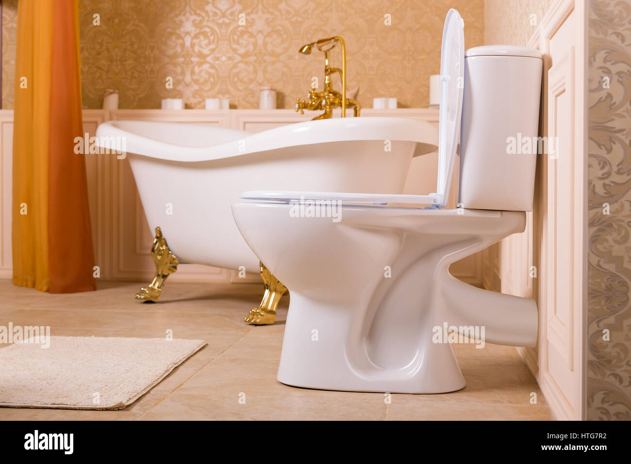 Luxury sanitary equipment with gold elements. Rich bath with gold roll-tops  in the form of animal paws, golden faucet and toilet in the bathroom Stock  Photo - Alamy