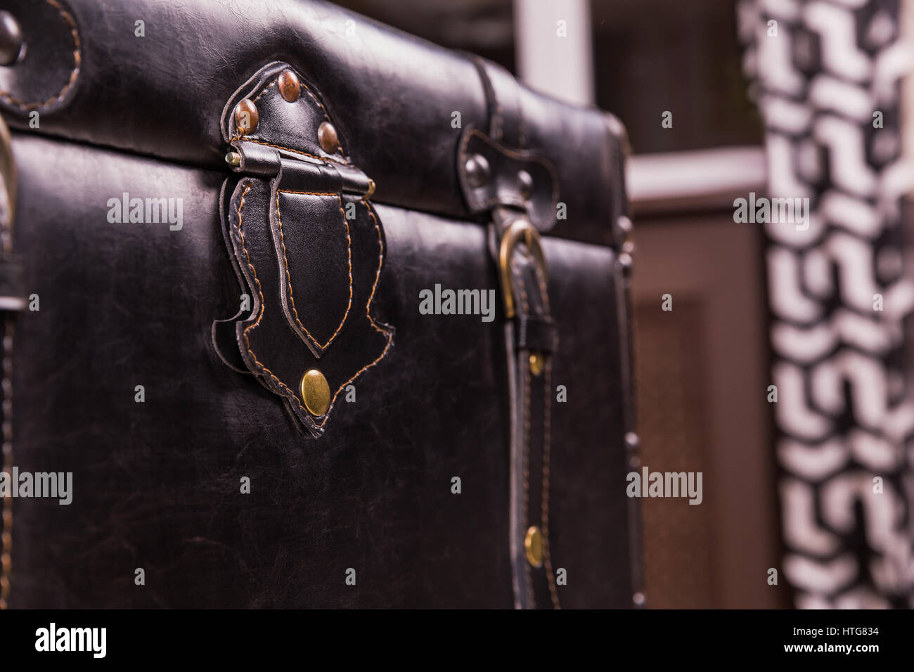 Black vintage suitcase leather texture. Old style bag clasp, buckle and belt closeup Stock Photo