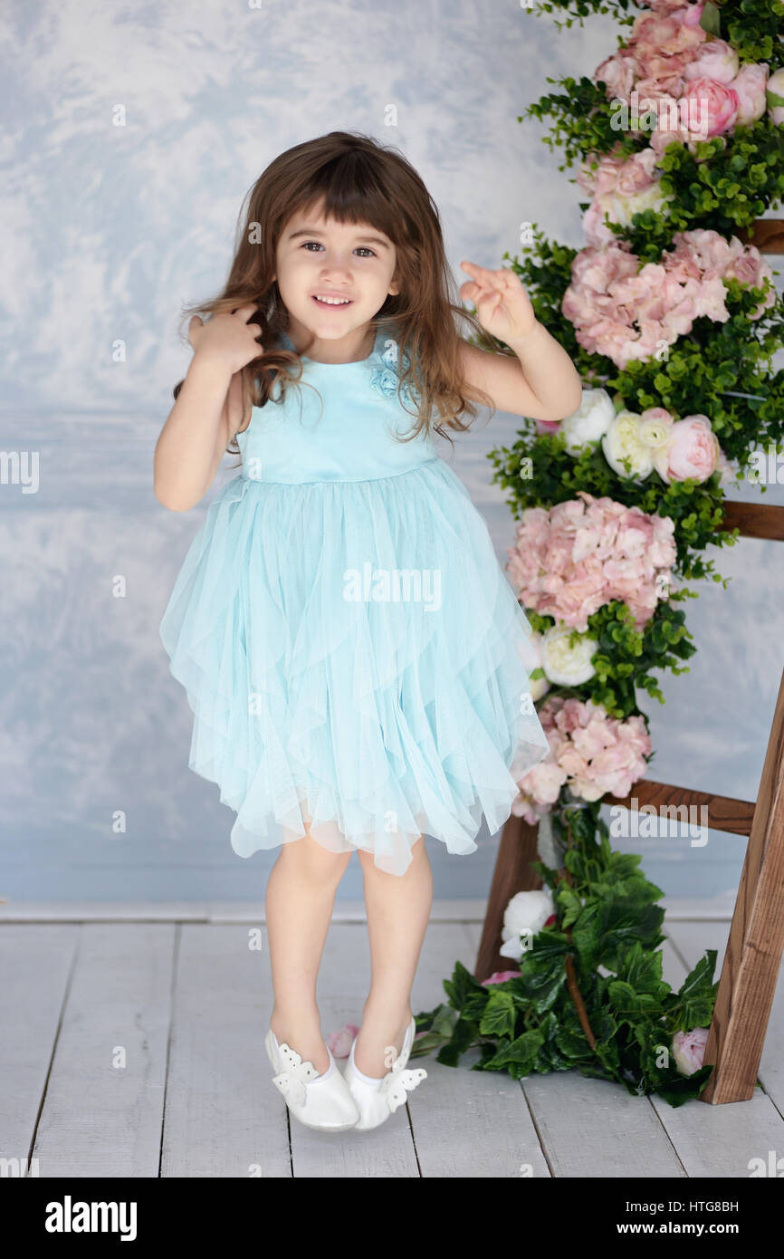 Laughing little girl in a blue dress with blue flowers and Ornamental staircase with white and pink flowers Stock Photo - Alamy Laughing little girl in a blue dress with blue flowers and Ornamental staircase with white and pink flowers Stock Photo - Alamy