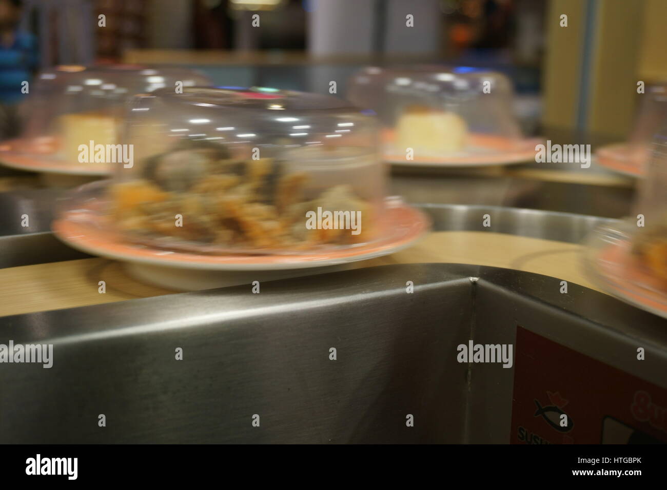 sushi on conveyor belt with motion blur Stock Photo