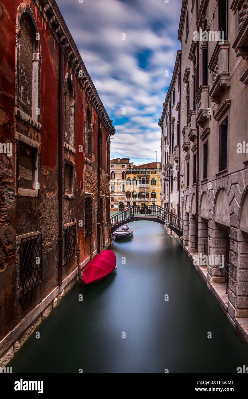 Long exposure of a quiet canal in Venice, Italy.  In the background is the Grand Canal. Stock Photo