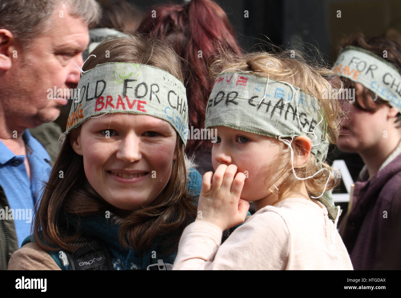 London, UK. March 11, 2017: A woman and her daughter wearing headbands ...