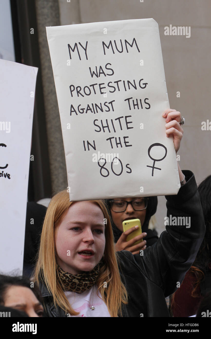 London, UK. March 11,  2017: A woman protestor holds up her placard at the 10th annual Million Women Rise march and rally in the street of London on March 11, 2017. The march, a commemoration of the International Women's Day started outside Selfridges on Oxford Street, followed by a rally at Trafalgar Square. the 2017 theme is "Be Bold For Change". © David Mbiyu/Alamy Live News Stock Photo