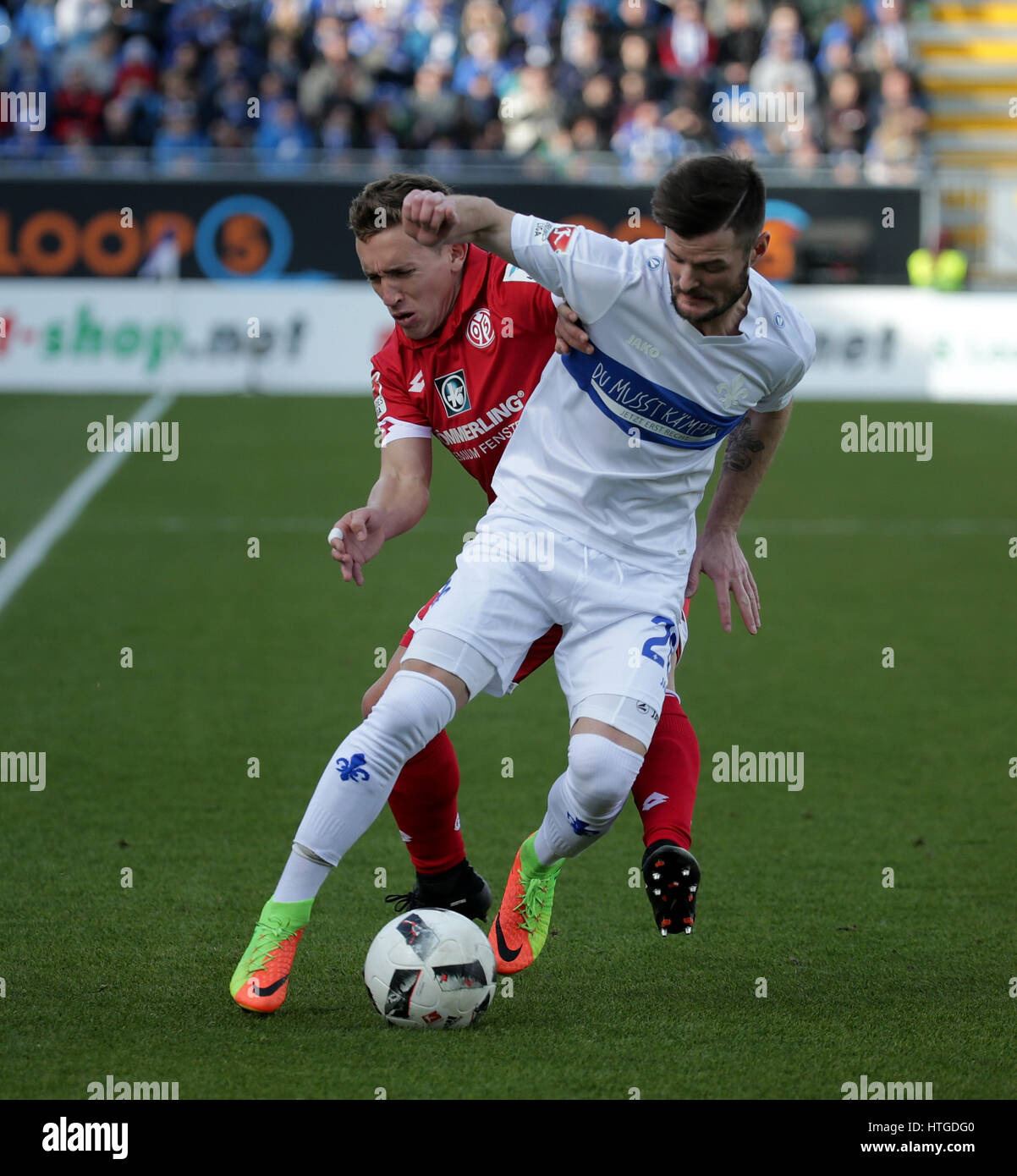 Darmstadt, Germany. 11th Mar, 2017. Darmstadt's Marcel Heller (R) and Mainz's Pablo De Blasis vie for the ball during the German Bundesliga soccer match between SV Darmstadt 98 and 1. FSV Mainz 05 in the Jonathan Heimes Stadium in Darmstadt, Germany, 11 March 2017.  Photo: Hasan Bratic/dpa/Alamy Live News Stock Photo