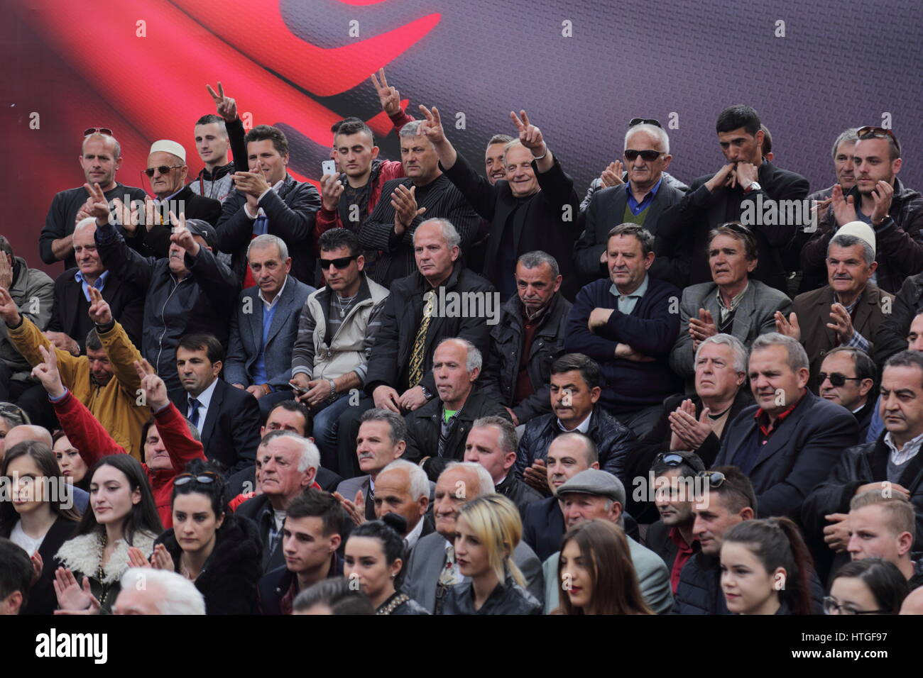 Tirana, Albania 11 March 2017. Political rally of Democratic Party of Albania in the course of election campaign 2017 in Albania: political supporters in the crowd Stock Photo