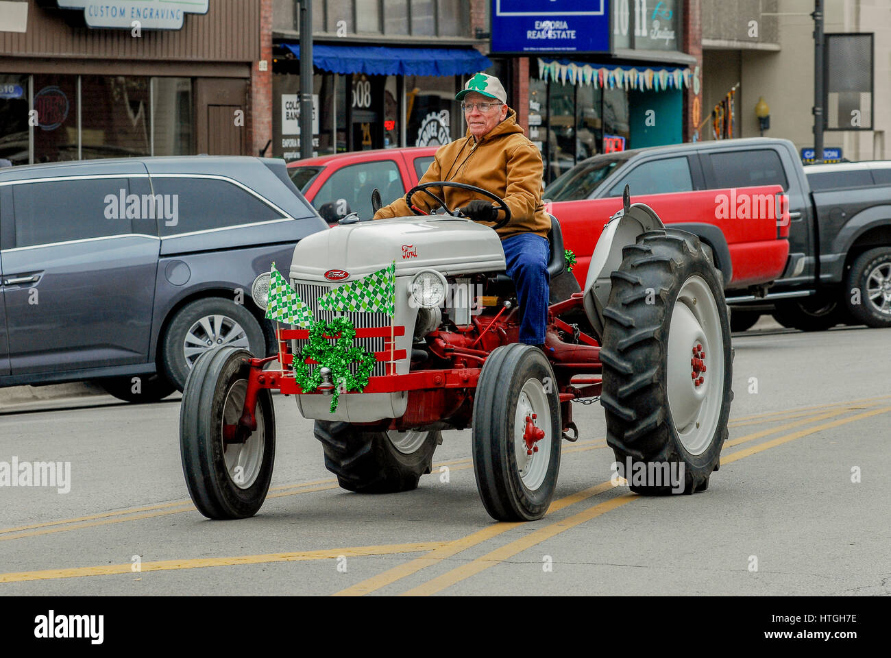 Emporia, U.S. 11th Mar, 2017. Antique tractors ride along during the Saint Patrick's day parade in a rural farming community today in Emporia Kansas, March 11, 2017. Credit: mark reinstein/Alamy Live News Stock Photo