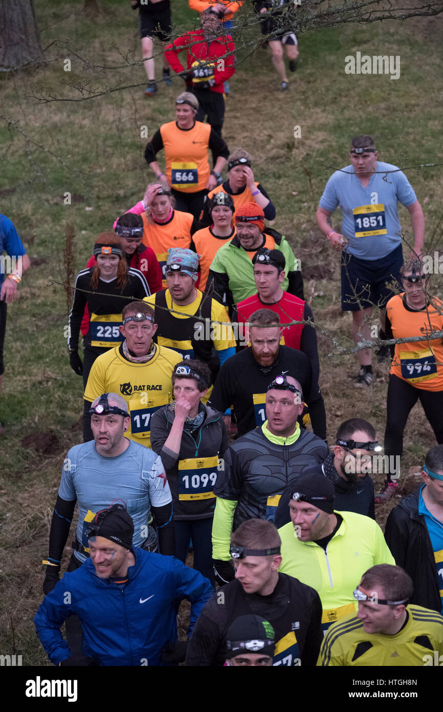 Traquair House, Innerleithen, UK. 11th March, 2017. Mighty Deerstalker 2017 Rat Race Adventure Sport, Mighty Deerstalker, 5k and 10k night obstacle race takes place over hills and through rivers and forests around Innerleithen. Scotland's original obstacle race and the hardest off-road night race that exists. 3000 Rat Racers take on rivers, mud pits, scrambles, dense forests and a mountain or 2 in this beautiful Scottish beasting. Afterwards, limber up for a bit of crowd surfing at the legendary Mighty Beerstalker afterparty. Credit: Rob Gray/Alamy Live News Stock Photo