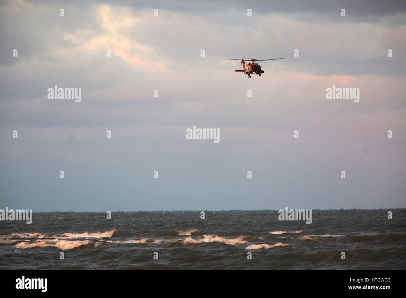 St. Pete Beach, Florida, USA. 15th Mar, 2017. SCOTT KEELER | Times.A US Coast Guard helicopter searches the Gulf waters off of Pass-A-Grille Beach, 3/15/17 for two missing boaters. The Gulf was rough due to onshore winds. Credit: Scott Keeler/Tampa Bay Times/ZUMA Wire/Alamy Live News Stock Photo