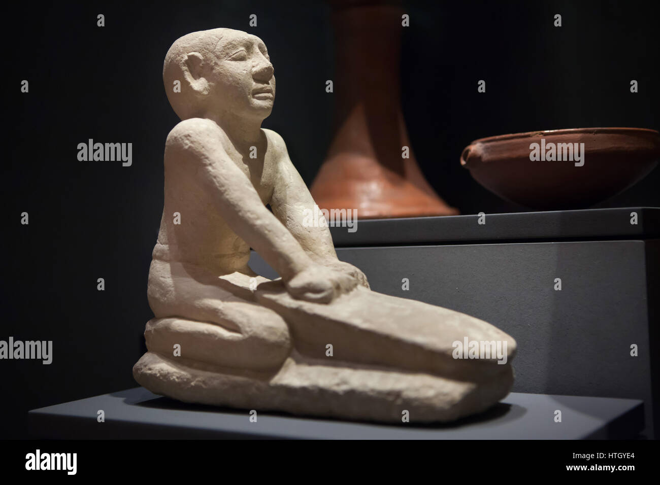Servant grinding flour. Limestone statue from about 2250 BC, 6th Dynasty, Old Kingdom of Ancient Egypt, on display in the Staatliches Museum Agyptischer Kunst (State Museum of Egyptian Art) in Munich, Bavaria, Germany. Stock Photo