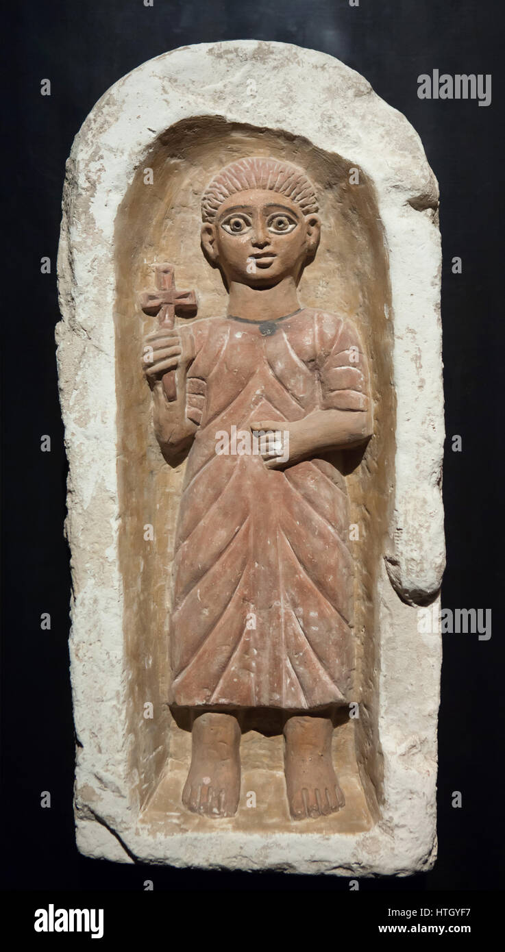 Youth framed by niche with a round arch. Coptic limestone tomb stele from Antinopolis, 4th century AD, on display in the Staatliches Museum Agyptischer Kunst (State Museum of Egyptian Art) in Munich, Bavaria, Germany. Stock Photo