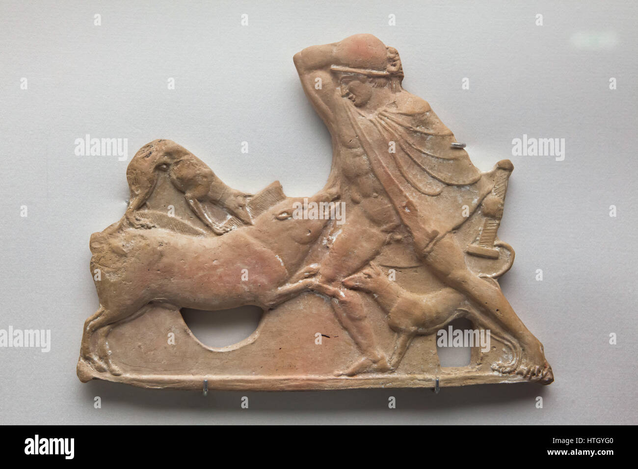 Meleager slaying the Calydonian Boar. Greek terracotta votive tablet from 475-450 BC found on Milos Island in the Aegean Sea on display in the Staatliche Antikensammlungen (Bavarian State Collection of Antiques) in Munich, Bavaria, Germany. Stock Photo