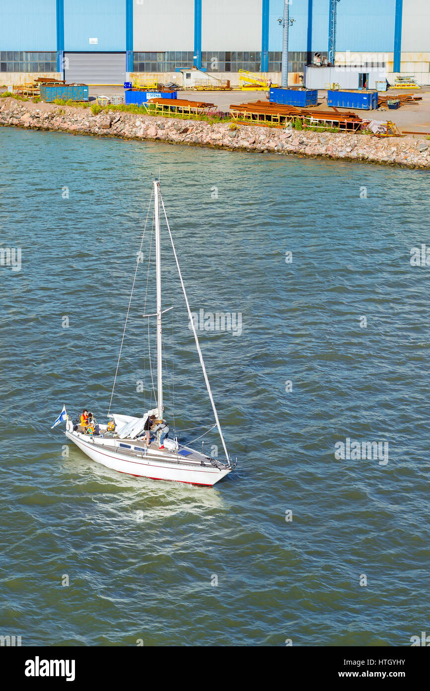 Helsinki, Finland - August 5, 2012: Sailing regatta in Bay of West Harbour. Sailing ship yacht involved in water sports. Young family with children ra Stock Photo