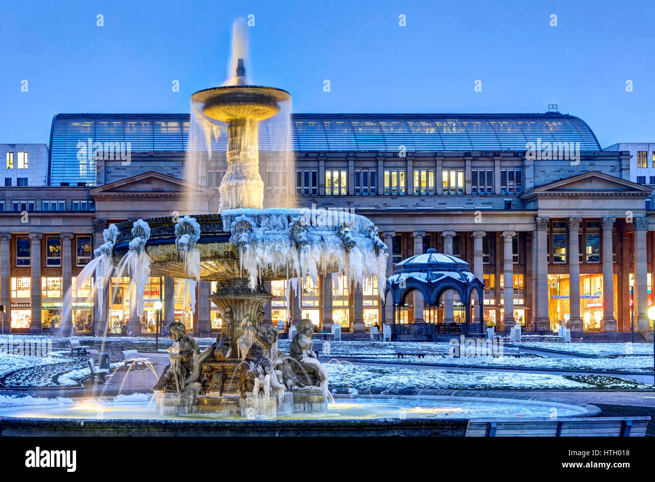 Frozen fountain at Schlossplatz Stuttgart, Königsbau Passage at back, Baden-Württemberg, Germany Stock Photo