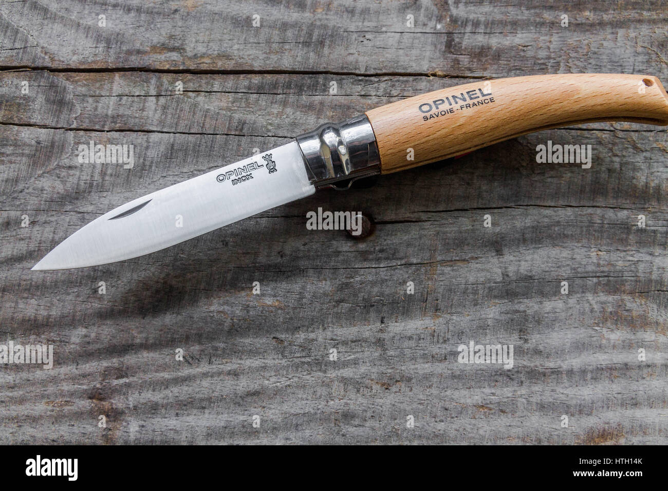 Pocket knife with a wooden handle. Wooden background. Stock Photo