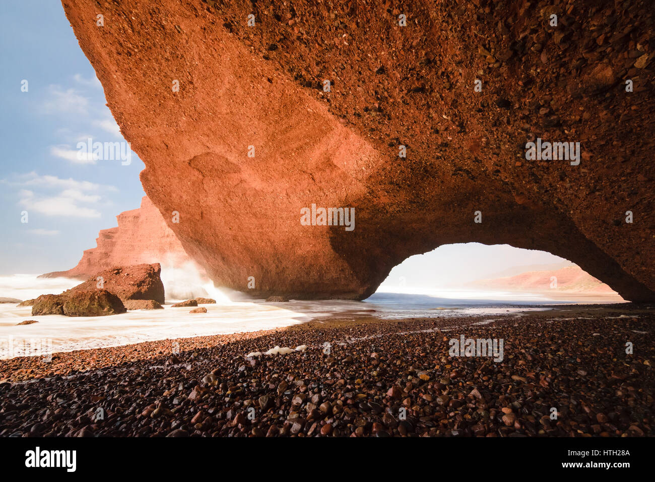 Red arches and rocky beach at the Atlantic Ocean in the region Sous-Massa-Draa, Sidi Ifni, Legzira, Morocco, Africa. Stock Photo