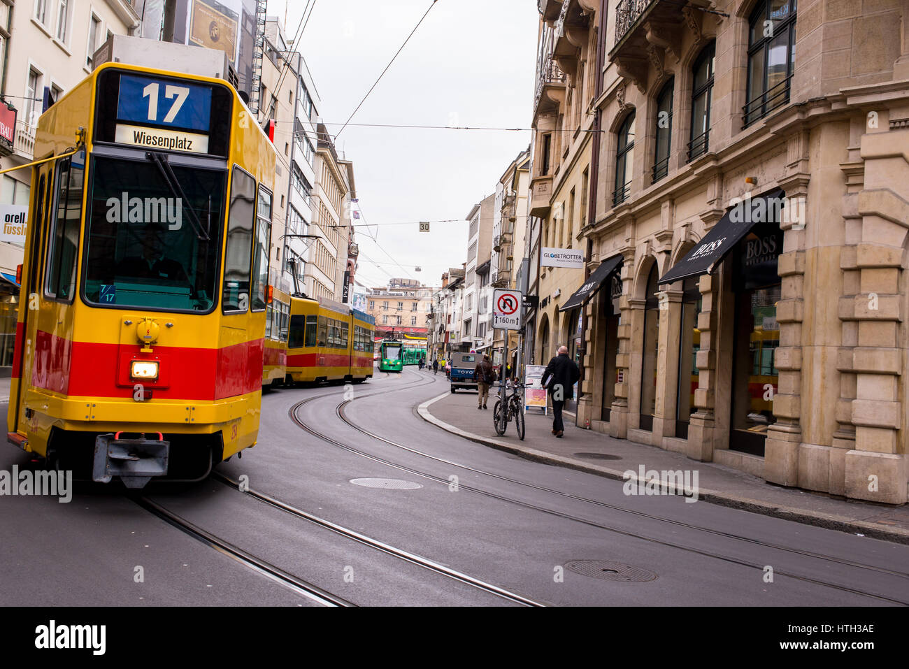 Basel, Switzerland - March 2017: Yellow tram in street of Basel city center. Basel's green and yellow trams have become an inseparable part of the cit Stock Photo