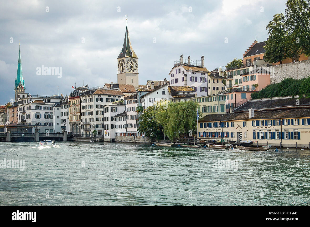 The Limmat Rowing Club, the St Peters Church and the Fraumunster Church along the Limmat River in Zurich, Switzerland Stock Photo