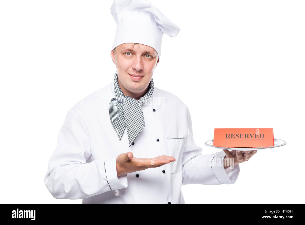 pretty professional cook with a tray on which there is a reserve ad Stock Photo