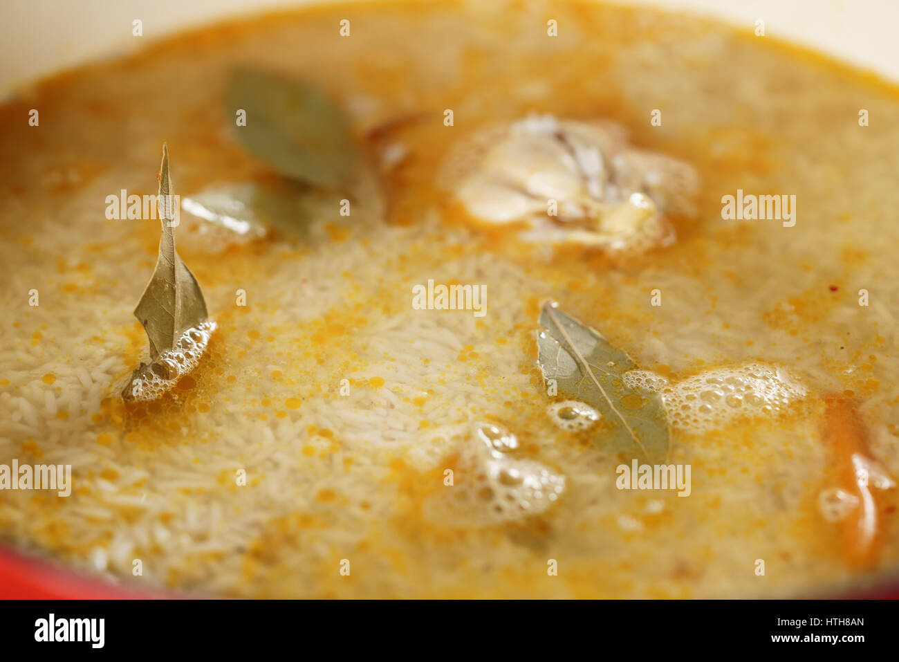pilaf covered by rice with bay leaves preparing, closeup photo Stock ...