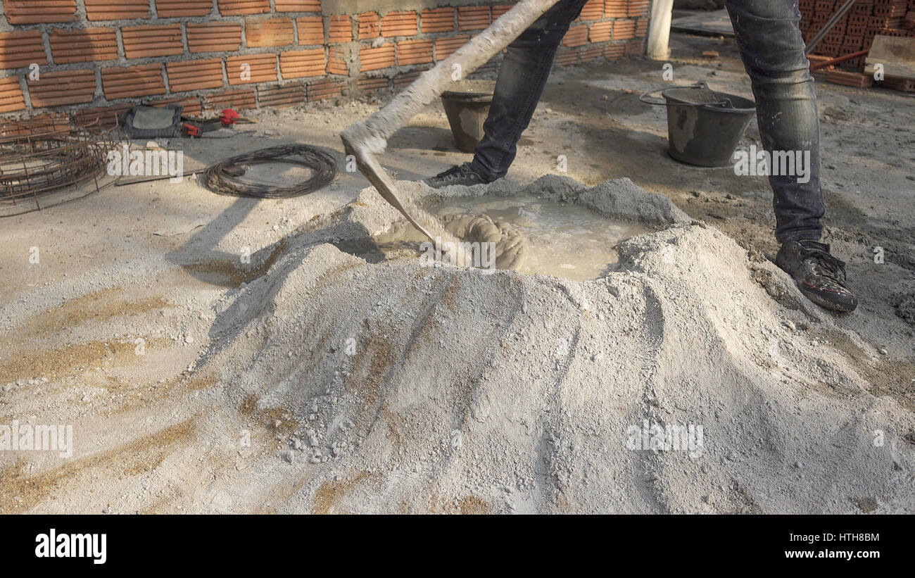 The cementers are mixing mortar for the construction of the wall Stock