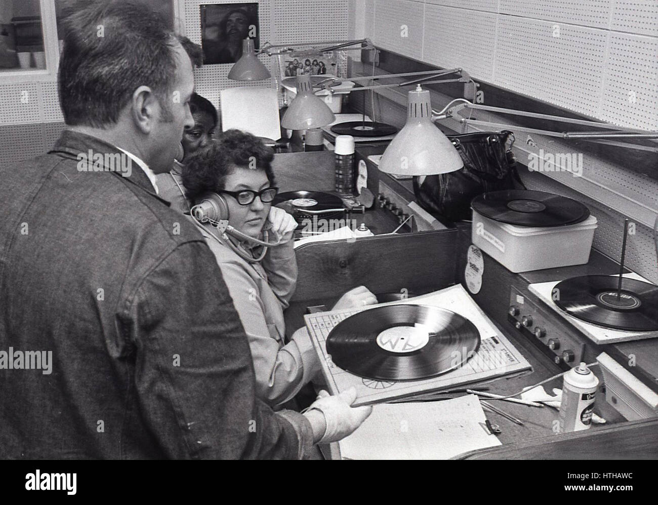 1970s, USA, female employee testing vinyl records of The Wobbles, at the CBS music company. Stock Photo