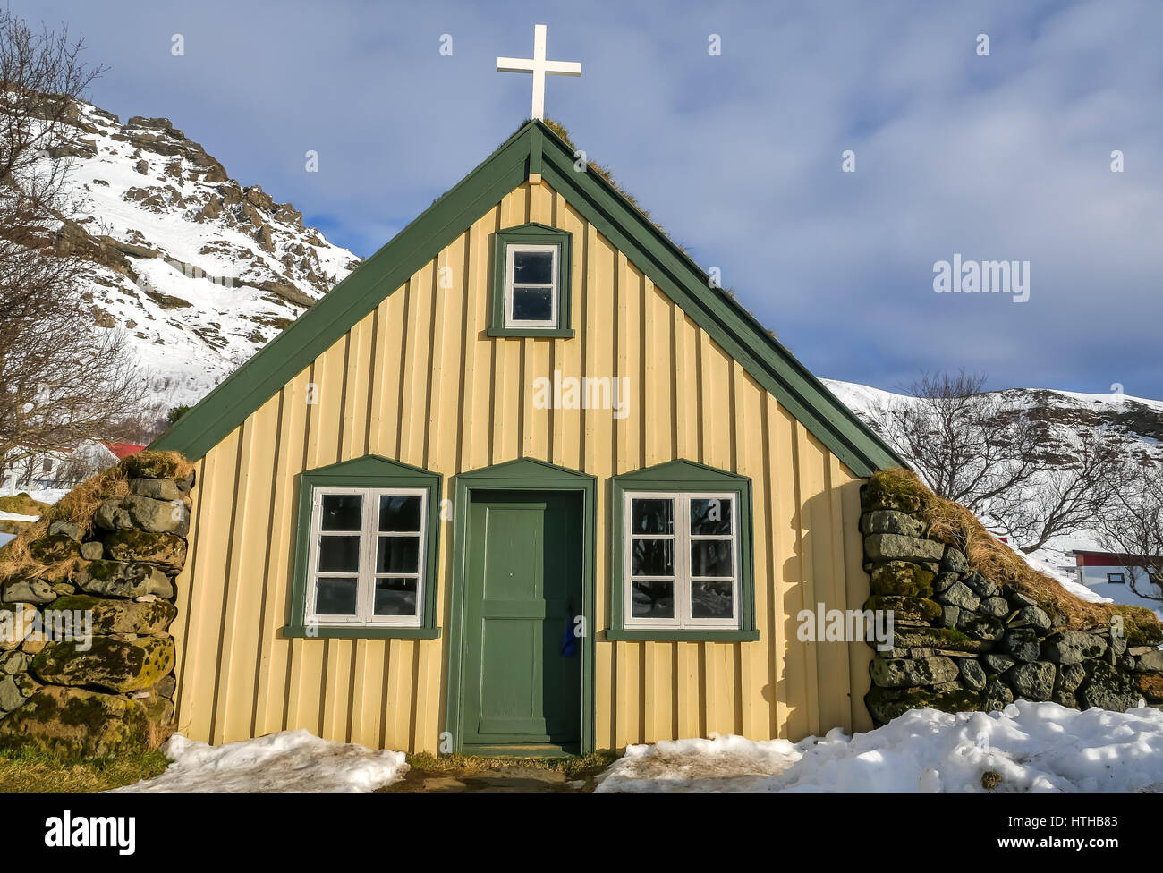 Quant little yellow painted old wooden church in Iceland in winter Stock Photo