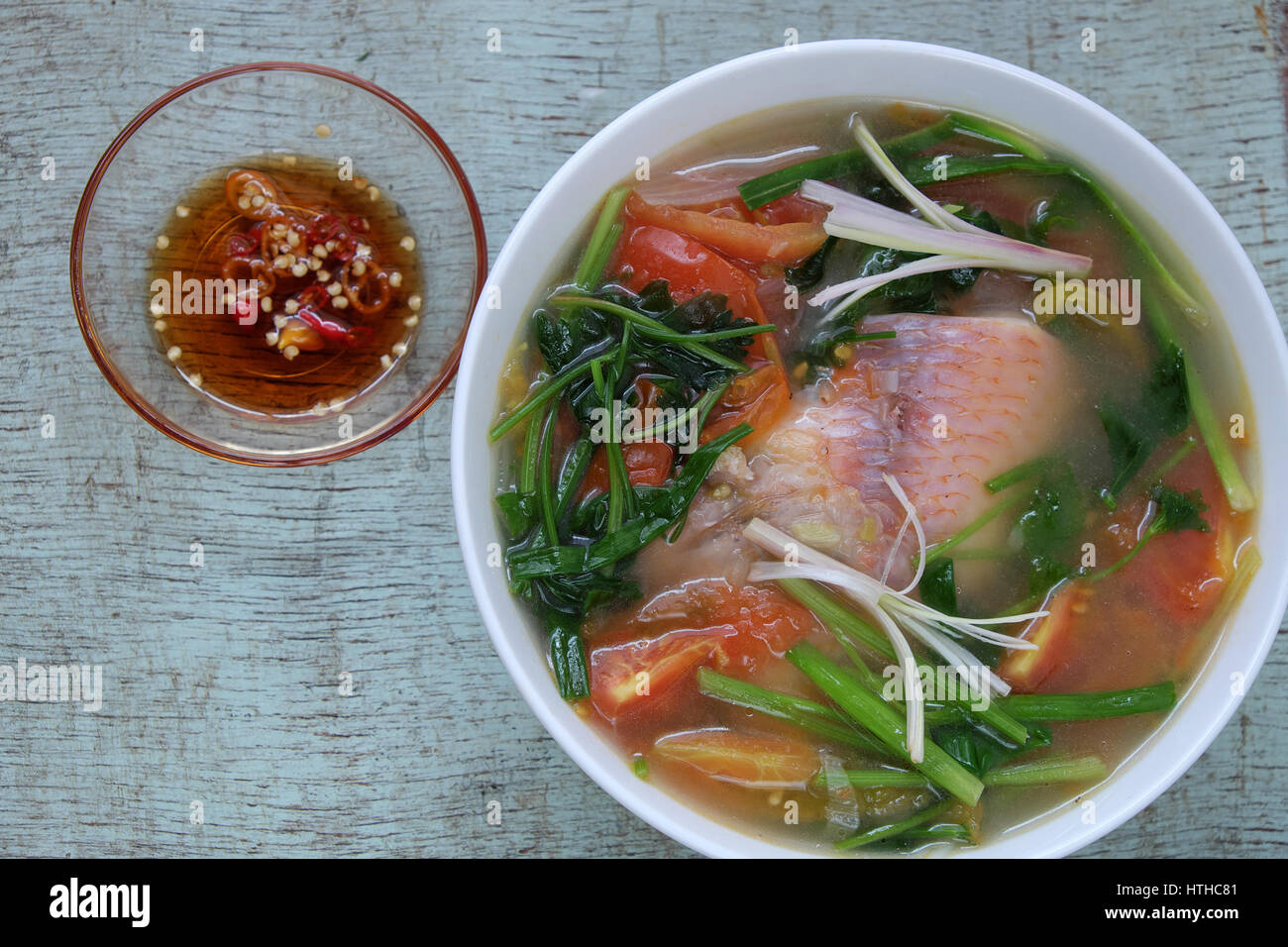 Vietnamese food, fish soup from tomato, onion, celery and red tiapia. Is popular daily dish that