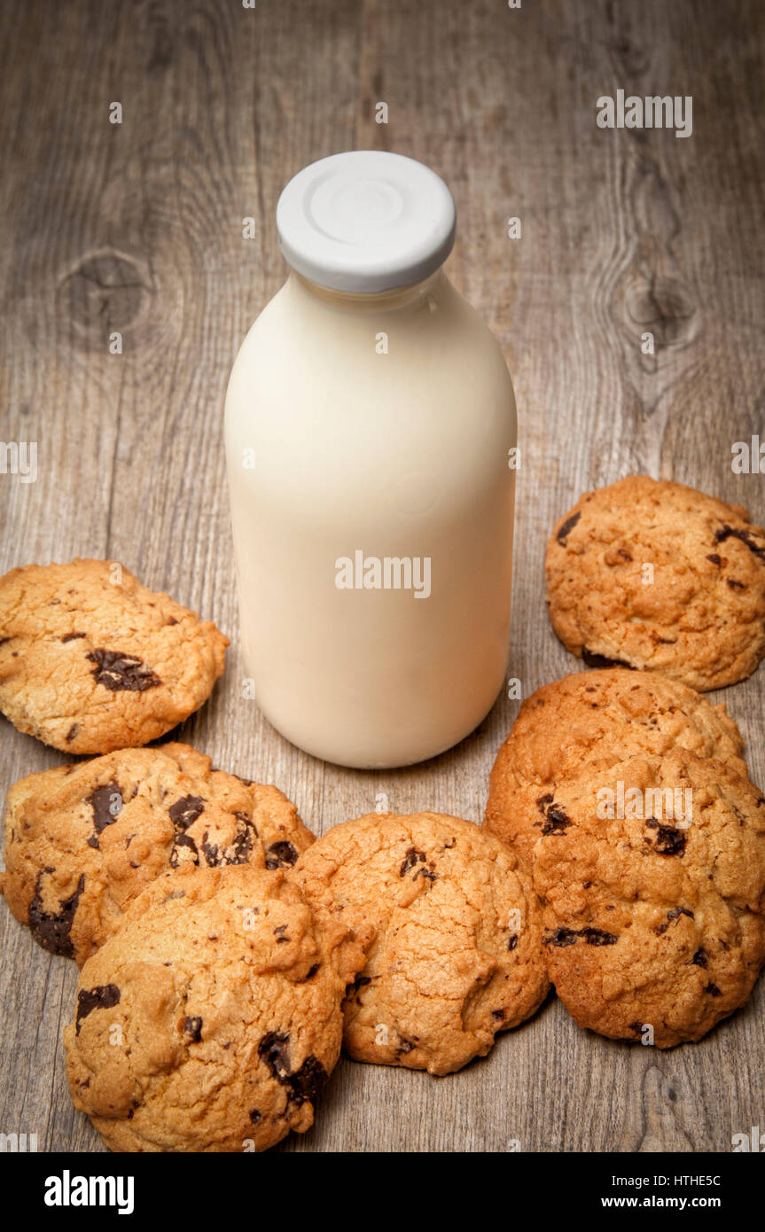 Milk and cookies. A bottle of milk with homemade chocolate chip cookies Stock Photo