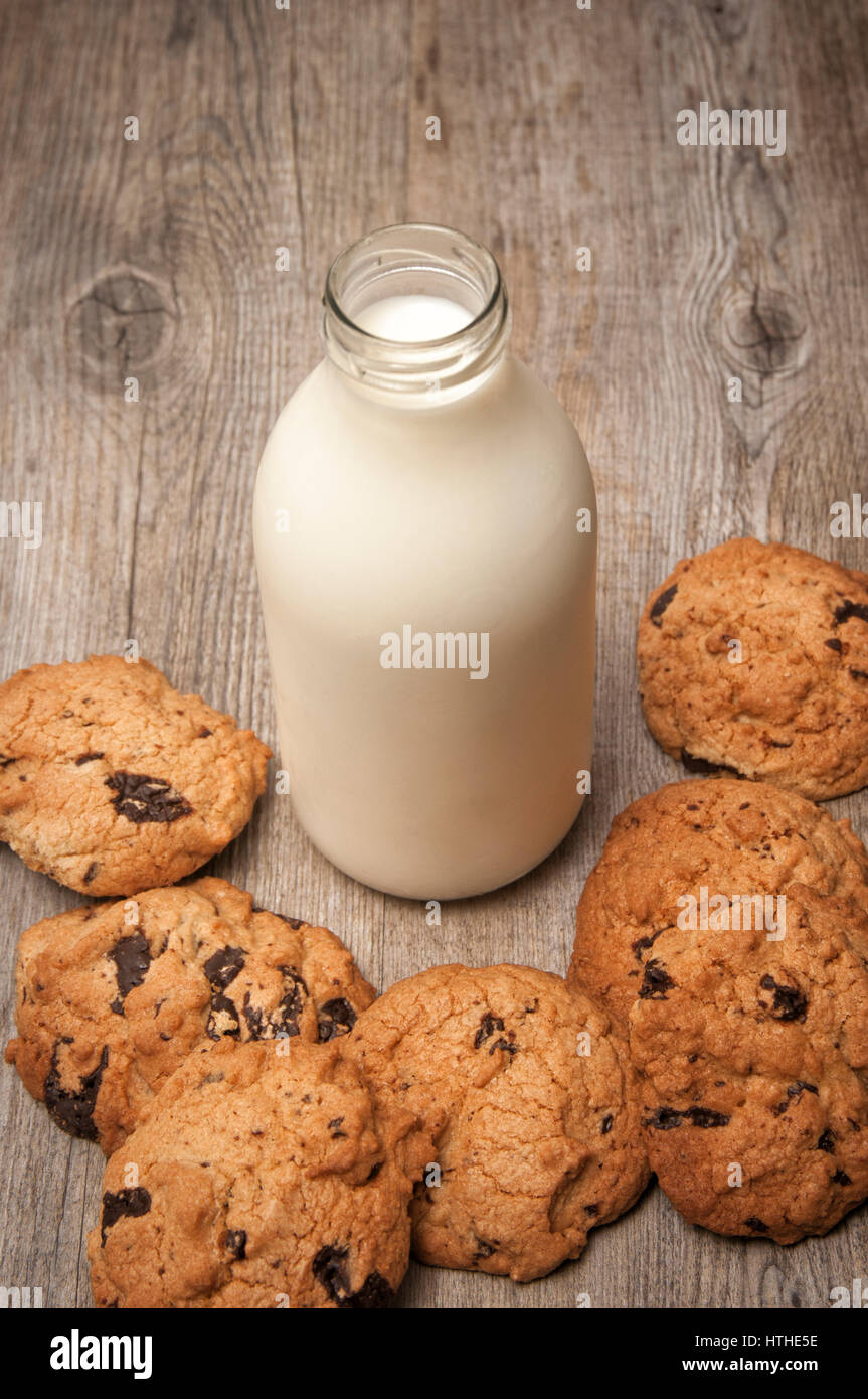milk and cookies. A bottle of milk with homemade chocolate chip cookies Stock Photo