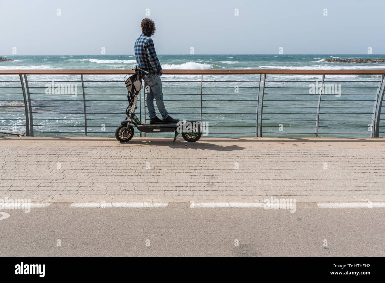 Man on electric scooter hi-res stock photography and images - Alamy