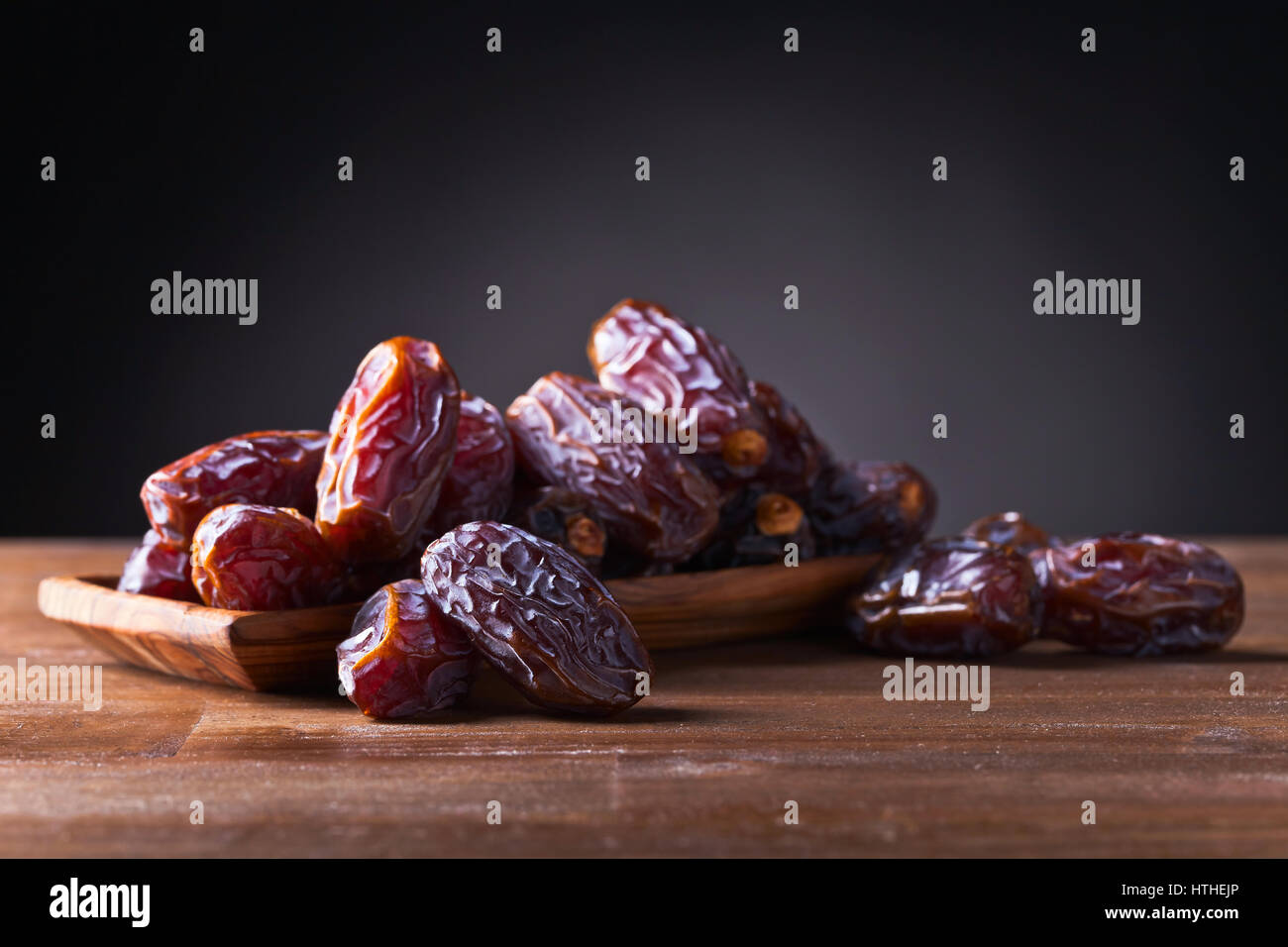 juicy ripe dates on a old wooden table Stock Photo - Alamy