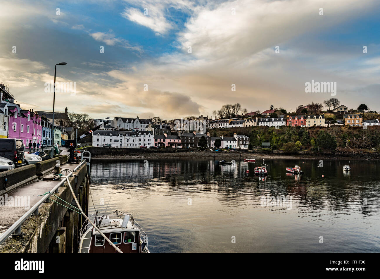 Portree Harbour, Isle of Skye, Scotland. March 2017, showing the row of coloured houses, set against a dramatic cloudscape. Stock Photo
