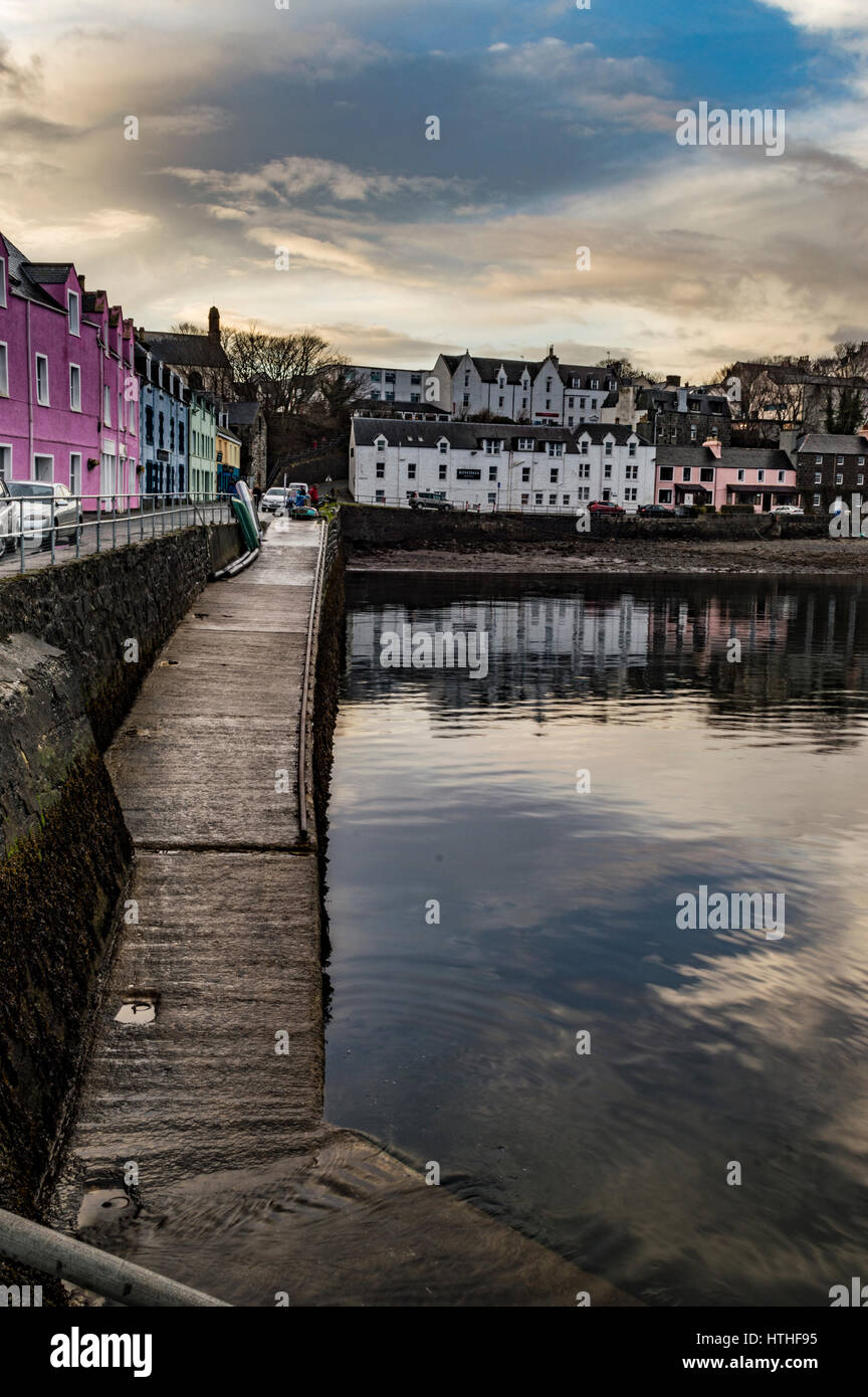 Portree Harbour, Isle of Skye, Scotland. March 2017, showing the row of coloured houses, set against a dramatic cloudscape. Stock Photo