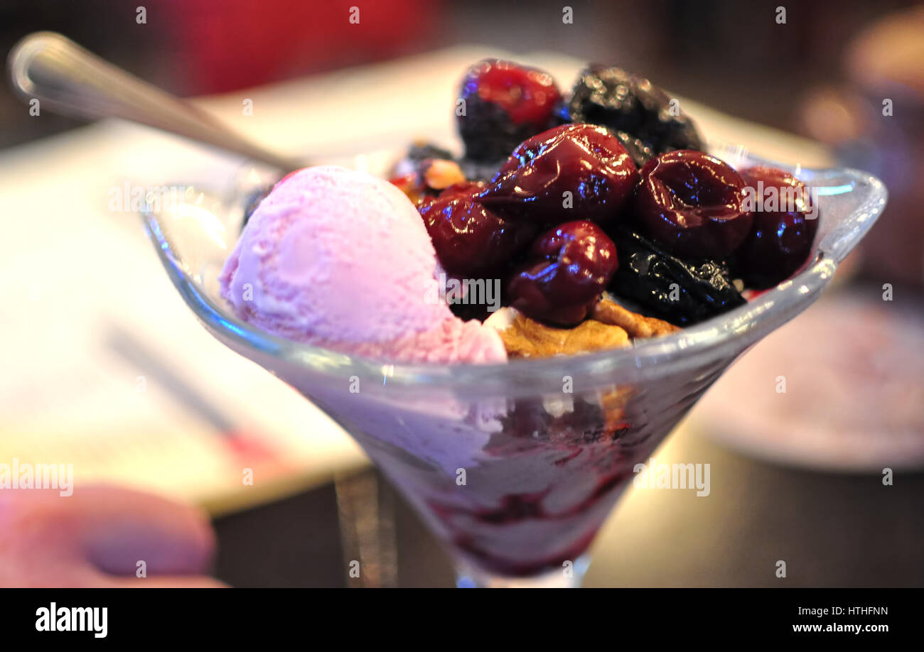Fruit ice cream with cherries and prunes at a cafe Stock Photo - Alamy
