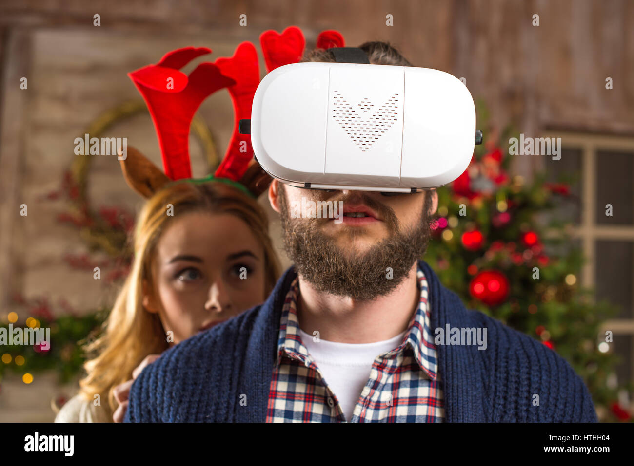 Couple using virtual reality headset Stock Photo - Alamy