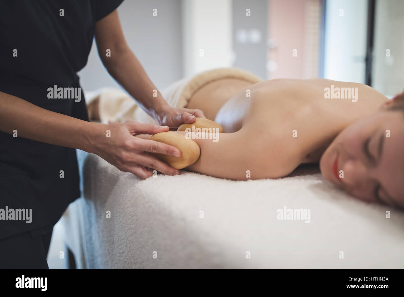 Cliend enjoying massage treatment given by masseur Stock Photo