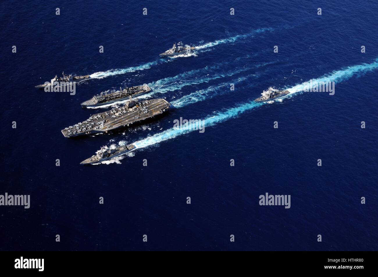 USN warships steam in formation during an underway replenishment September 19, 2010 in the Pacific Ocean. Stock Photo